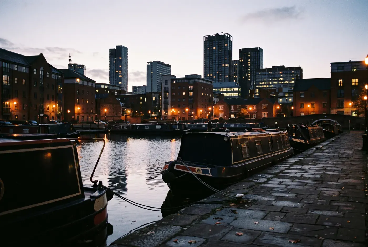 Birmingham city centre skyline at dusk across the canal basin